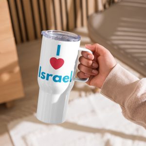 A hand holding a white travel mug with a handle and clear lid, featuring the text “I Love Israel” in blue and red, set against a warm indoor background.