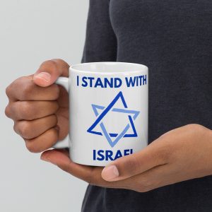 Person holding a white mug with “I Stand With Israel” text and Star of David design.