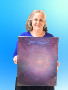 Rikki Rose holding one of her paintings