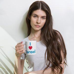 Woman holding a white mug with “I love Israel” text printed on it.