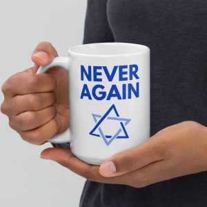 Person holding a white mug with “Never Again” text and Star of David design.