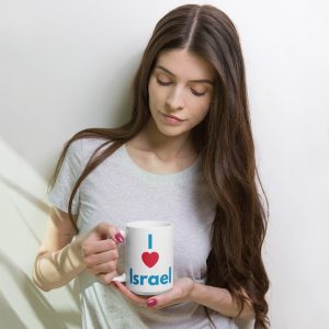 Woman holding a white mug with “I love Israel” text printed on it.