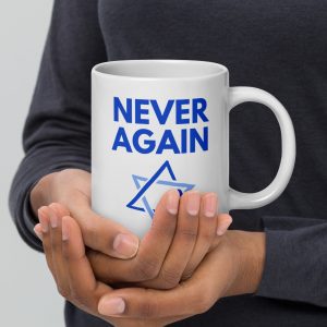 Person holding a white mug with “Never Again” text and Star of David design.