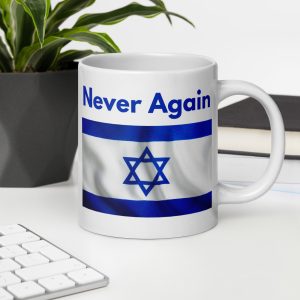 White mug with “Never Again” text and Israeli flag design on a desk with keyboard and plant.