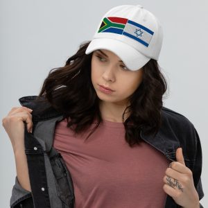 White cap with embroidered South Africa and Israel flags worn by a woman.