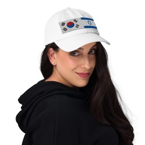 White cap with embroidered South Korea and Israel flags worn by a woman.